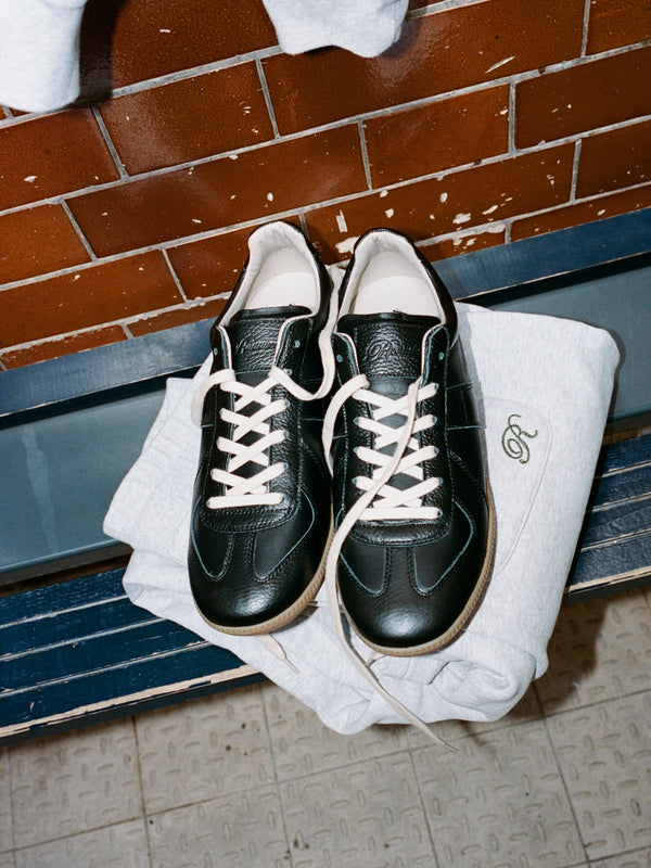 Some designs never really disappear

Originally developed as a military training shoe in 1970s West Germany, the “GAT” (German Army Trainer) earned its reputation for functionality & style

Our Portuguese-made Homage Trainer takes that same foundation and reworks it in our own way, keeping the proportions, simplicity and versatility that made the original enduring

We shot it somewhere with a similar sense of history - a Victorian bathhouse turned boxing gym in London’s East End
