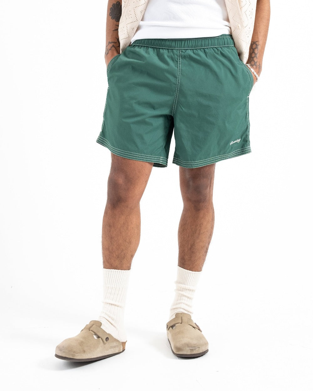 male model wearing dark green swim shorts