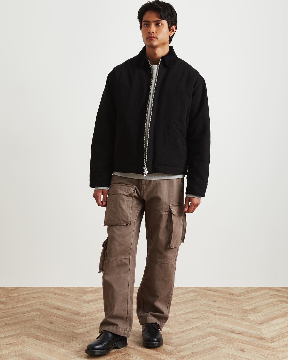 model wearing ronning's black zip up work jacket